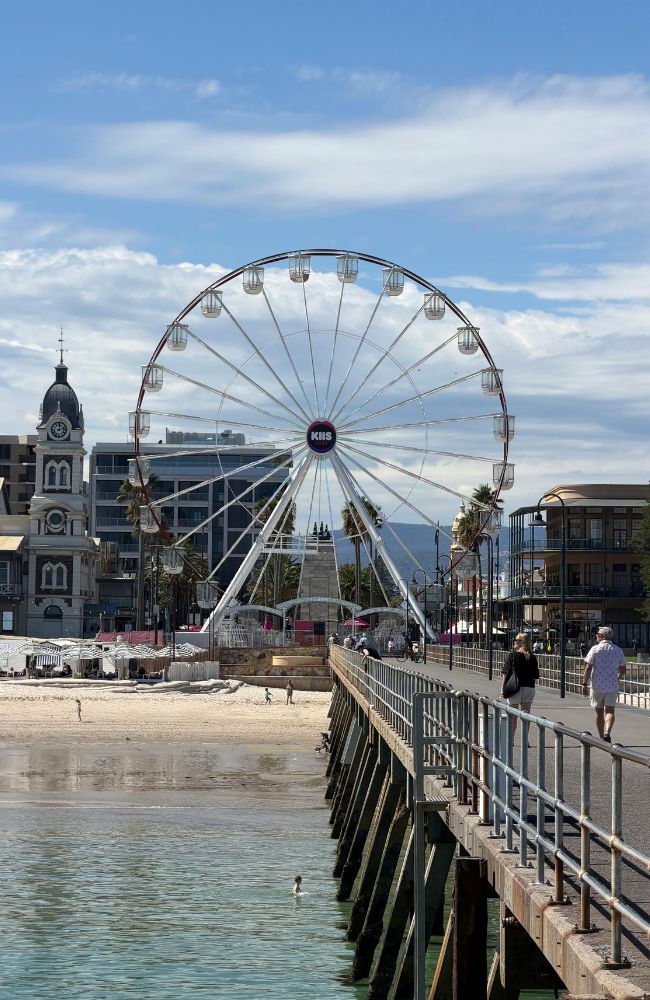 People walking along a jetty, enjoying outdoor activities in Adelaide with Adelaide Locals. People walking along a jetty, enjoying outdoor activities in Adelaide with Adelaide Locals.